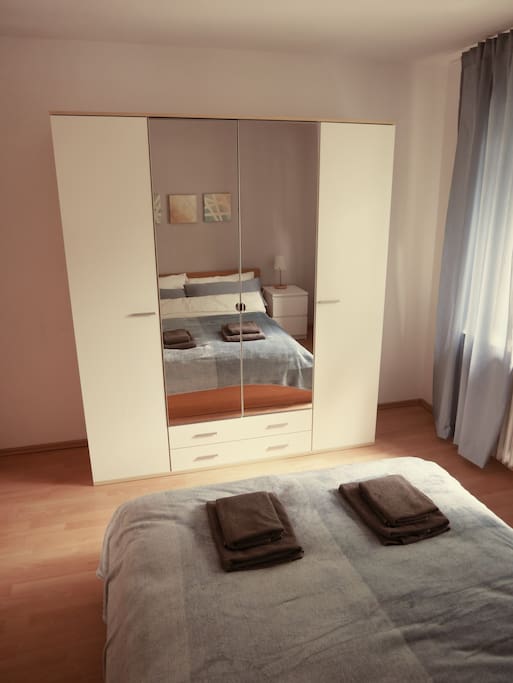 The bedroom has a nice big wardrobe with a mirror