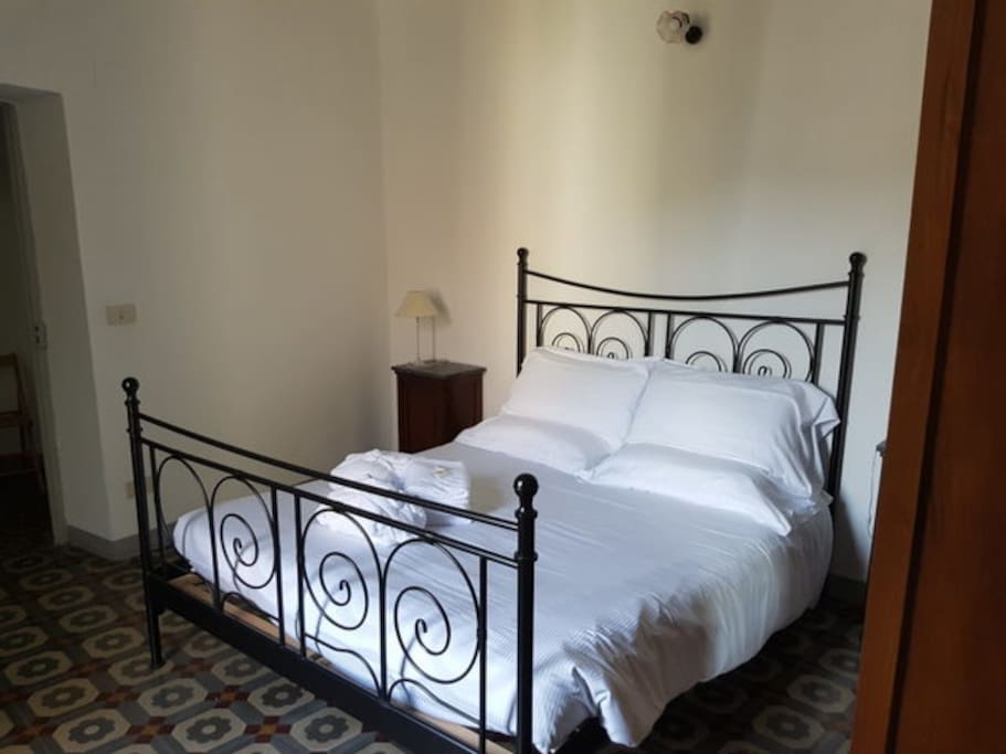 Bedroom with double bed and outside balcony