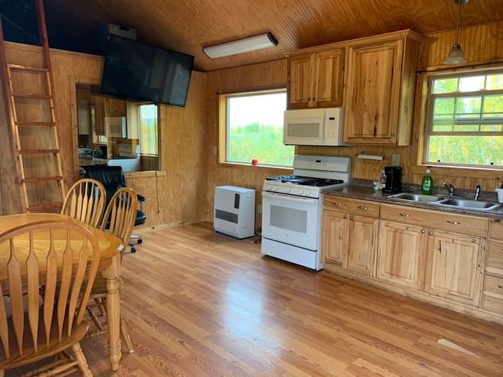 Kitchen table with seating for four.  Full kitchen appliances