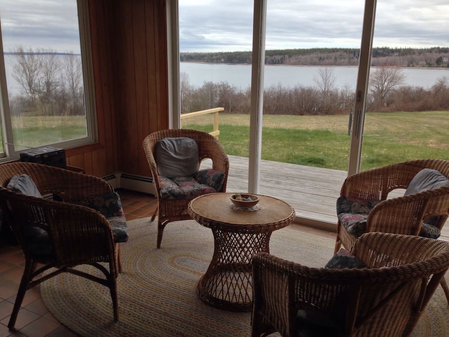 The sun porch is a closed-in glass room that has a nice view of the water, sunrises and sunsets. Beyond this room there is also a deck with seating outside.
