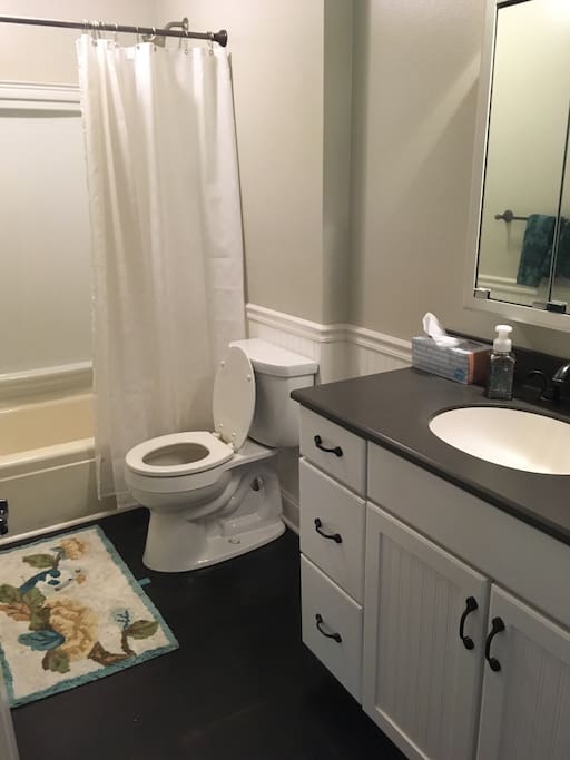 Private bathroom with shower and bathtub