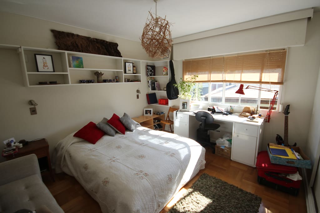 A view of the room. It has a comfortable Queen size bed with feather blankets, a wide window, a big closet and a great working desktop!