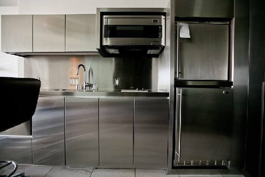 Kitchen: dishwasher, stove, microwave, refrigerator, drinks cooler
