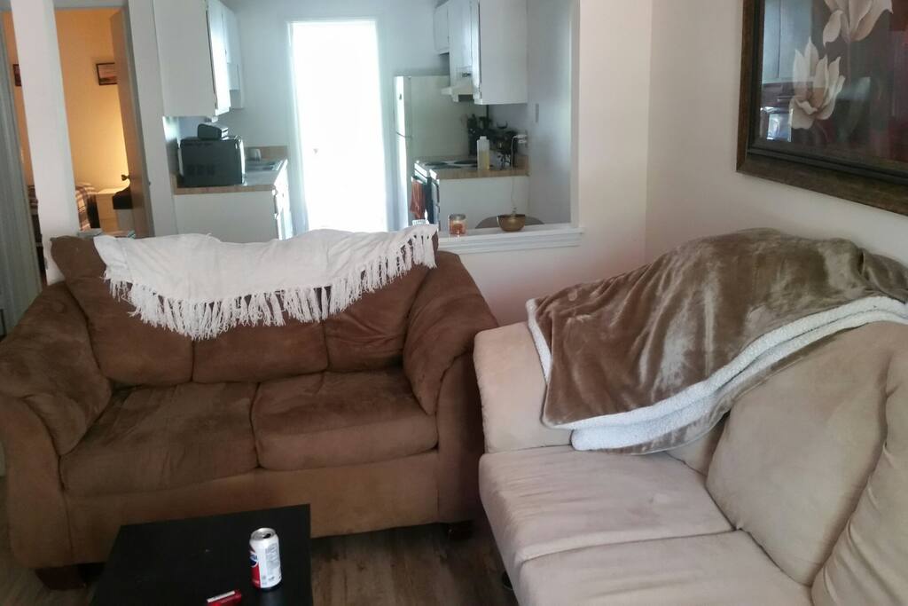 living room with microfiber couch and love seat