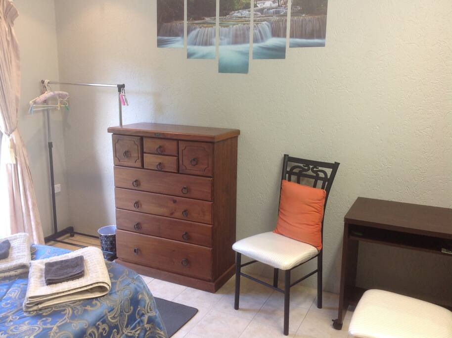 Desk, two chairs, hanger and chest of drawers.