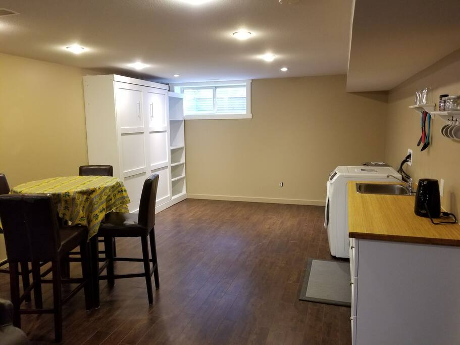 Kitchen, eating area and a queen size Murphy Bed in the distance.