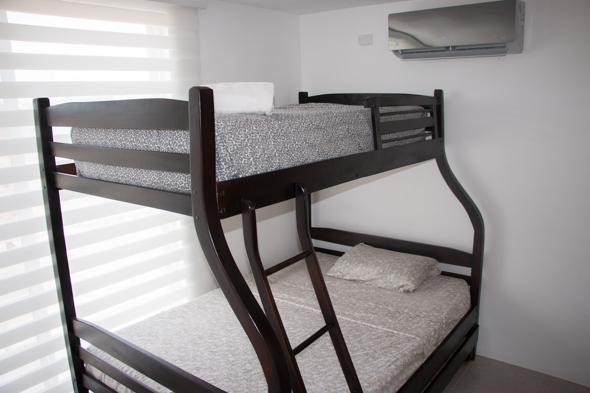 Room 3 with bunk bed, air conditioner and closet. This bedroom has an outdoor balcony.  

Bedroom 2 and 3 share the bathroom. 