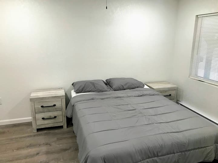 Bedroom with queen size bed along with nightstands with USB charging ports.