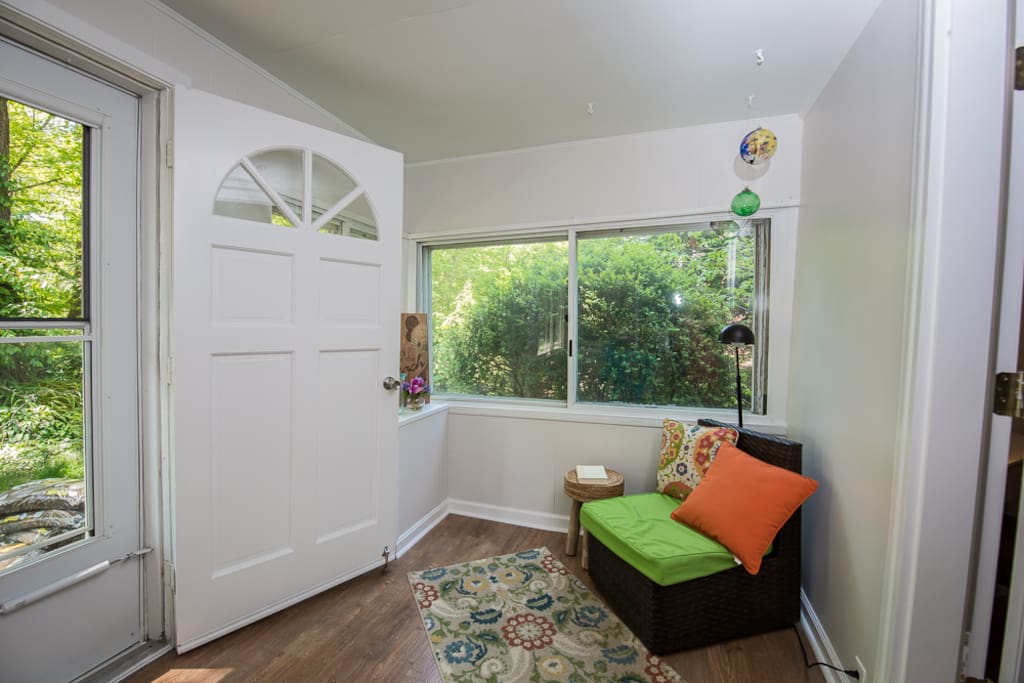 Front porch has a lovely chair and bistro table to hang out on for a quiet morning with your cup of tea or coffee.