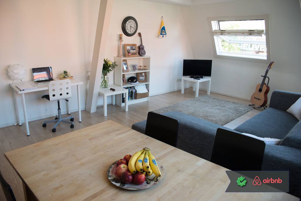 A large, well-lit and cozy living room to dine and relax