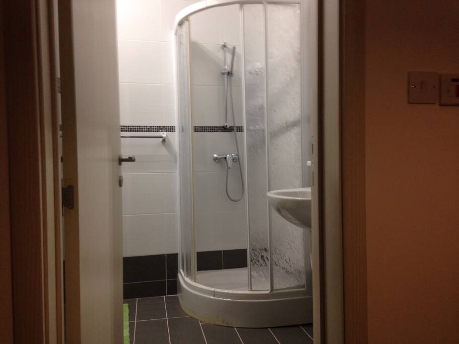 Bathroom including a shower, toilet and a wash hand basin