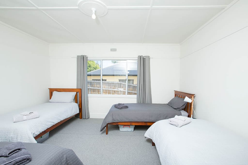 4 single beds in second bedroom