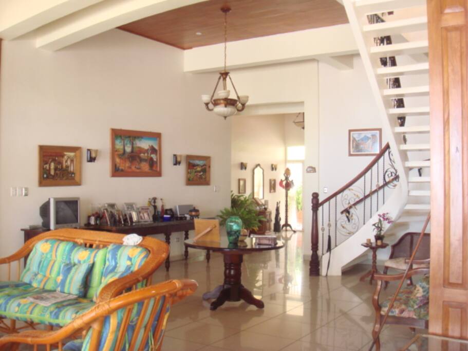 In these images you can see the entrance to the house the double front door is constructed of PVC, ideal for properties located at oceanfront, the PVC material is totally resistant to salinity and does not deteriorate over time, the entire property has these types of doors and windows.
view of the stairs to the second floor where the master bedroom, bathroom, Jacuzzi, office, balcony in front of the sea and balcony in front of the entrance to the property, both equipped with supports for hammocks is where you can relax fully in privacy, peace and tranquility on the second level.