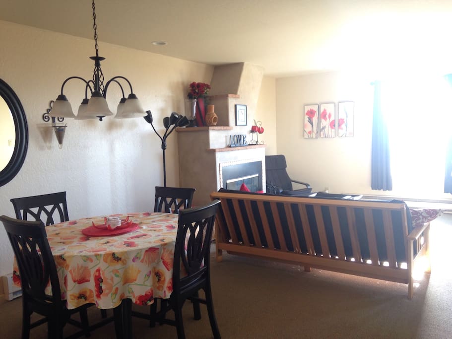 Dining and living areas + fireplace with dunes and ocean views