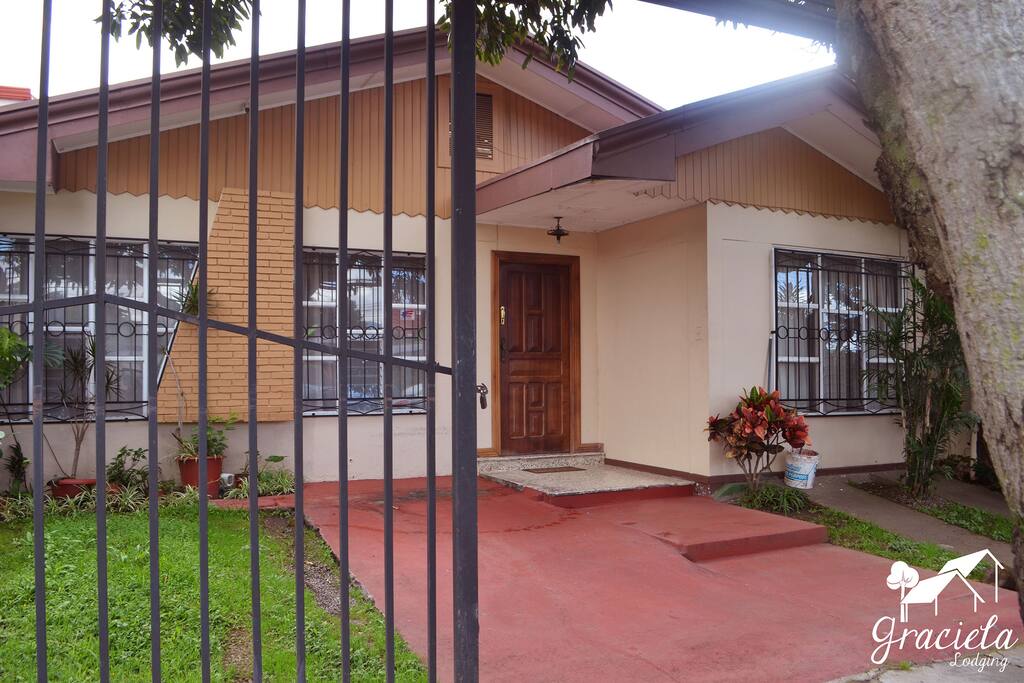 Front view of the home. Gated parking for one vehicle, in this area.