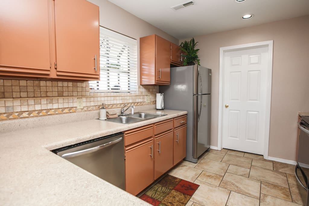Kitchen. Has microwave, range / oven, dishwasher with detergent, & fridge & ice maker.