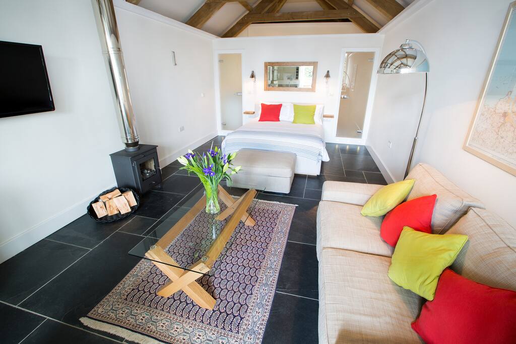 TV and Seating Area with Woodburner through to the Bedroom