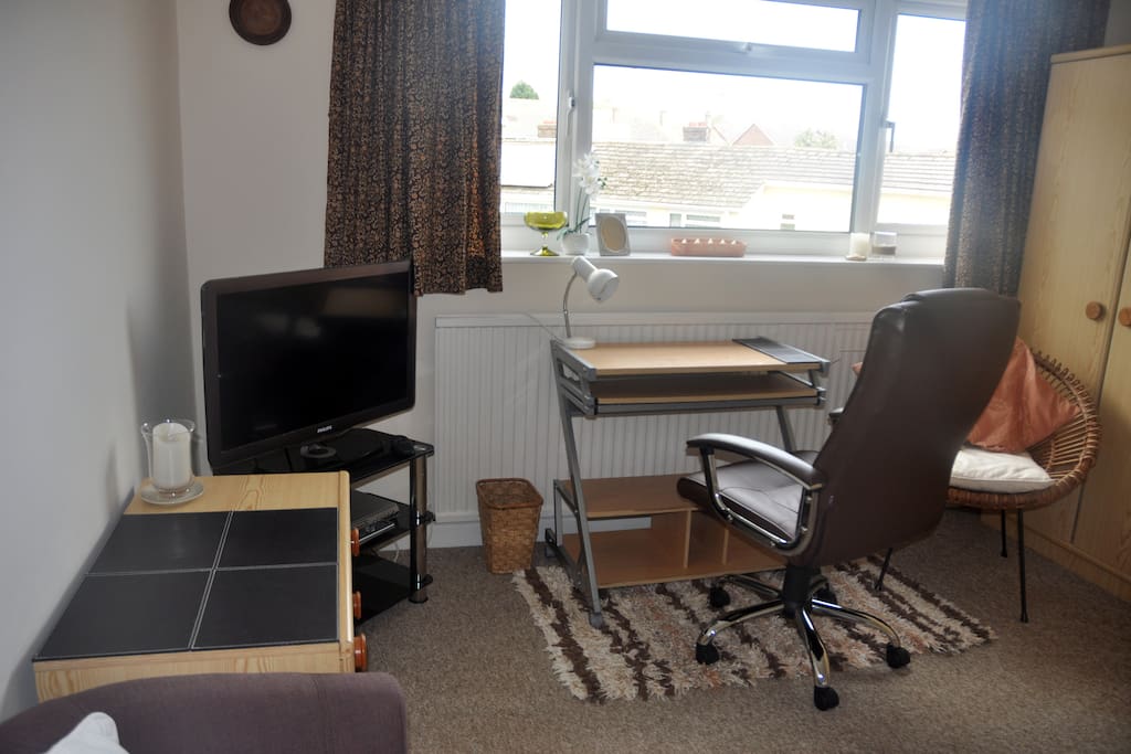Bedsit showing TV and desk.