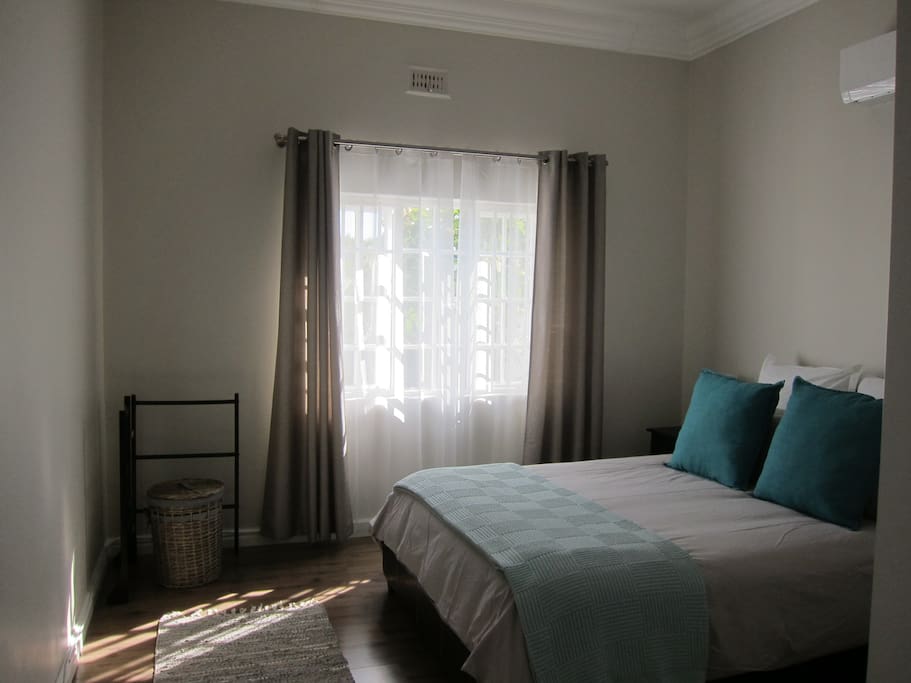 Main bedroom with queen bed and airconditioning