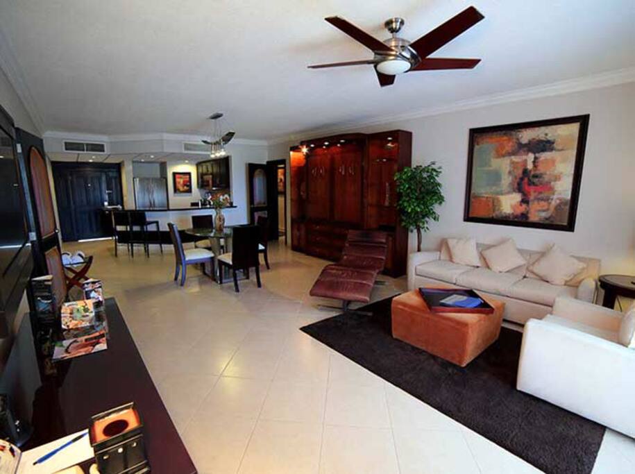 Living, dining and kitchen in open floor plan setting with Murphy bed.