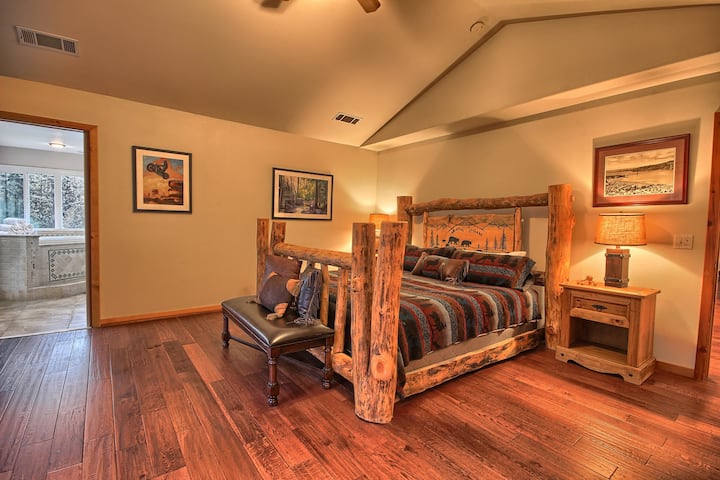 The master bedroom features an impressive custom hand carved log bed.