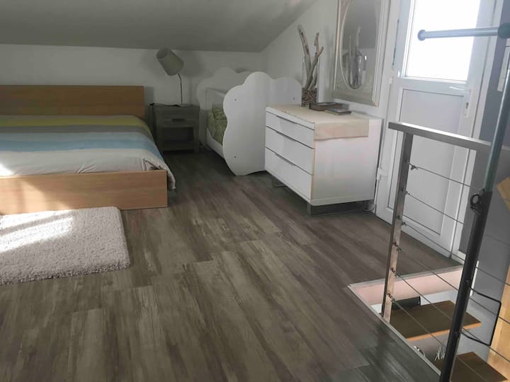 Upstairs 1 26m attic bedroom with large bed in 160  2 nightstands and crib  seating area and plenty of storage 