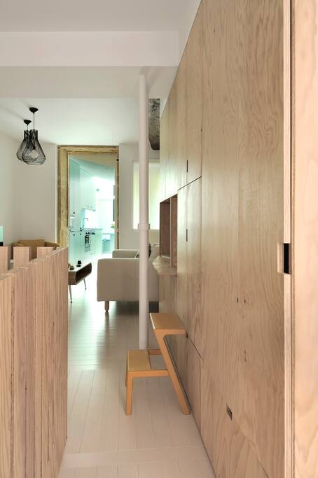 Vue de la porte d'entrée avec au fond la cuisine, à droite la chambre parentale et à gauche l'escalier vers la chambre 2 bureau