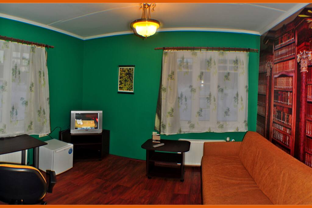 Living area (sofa also to be used as a sleeping place for 1 adult or 2 children). TV, fridge, desk.
