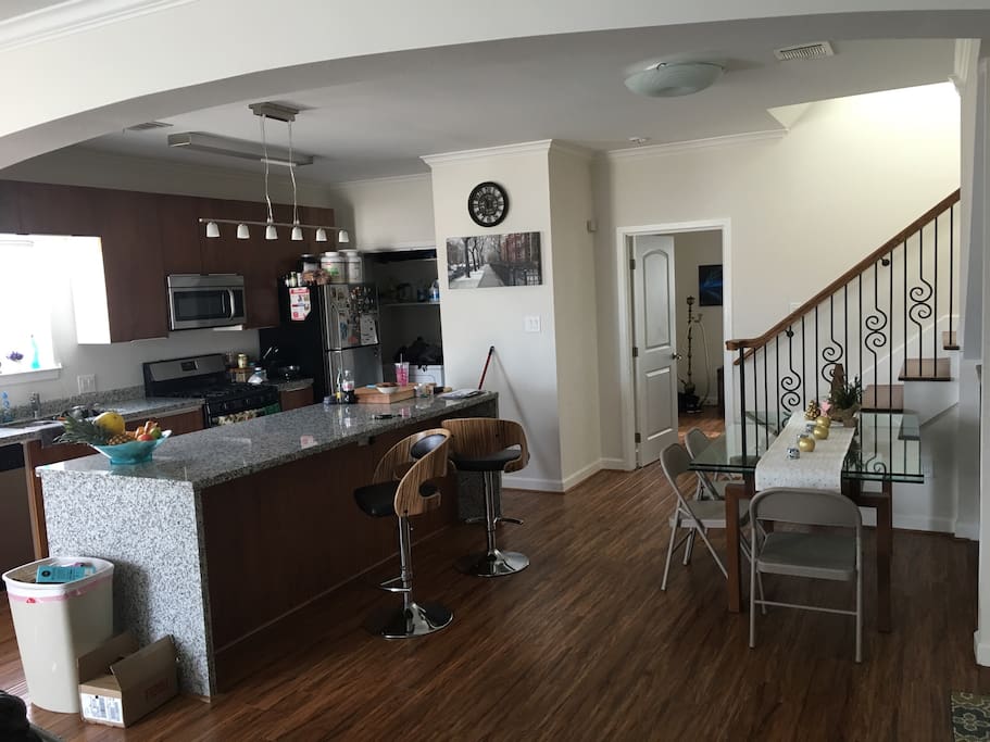 Gas stove, washer and dryer, dishwasher, microwave, kitchen table, and bar stools.