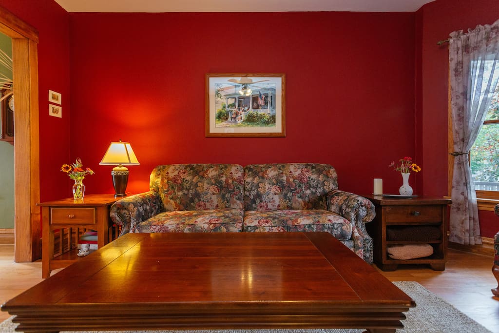 The red living room greets you.