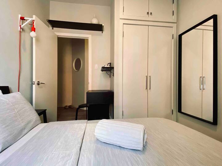 Your room includes a closet, a compact desk with a stool, and a comfy chair. Please let us know if there's anything else you need during your stay!
