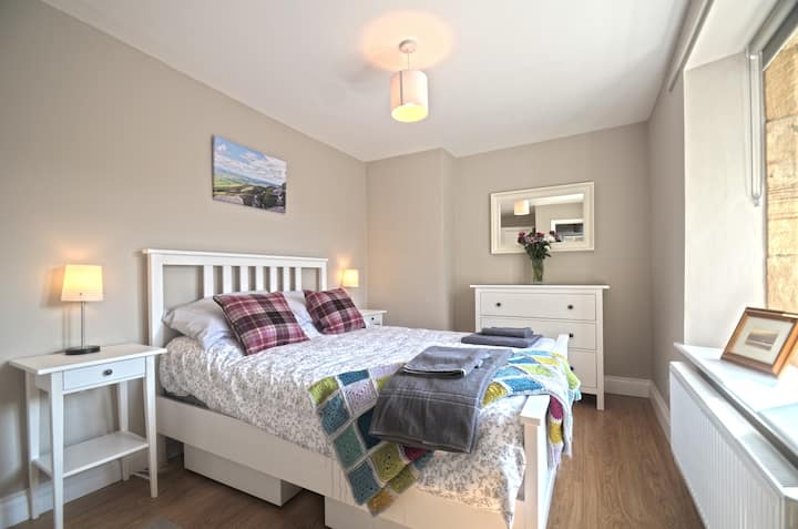 The modern Bedroom offers a double bed, large wardrobe and chest of drawers.