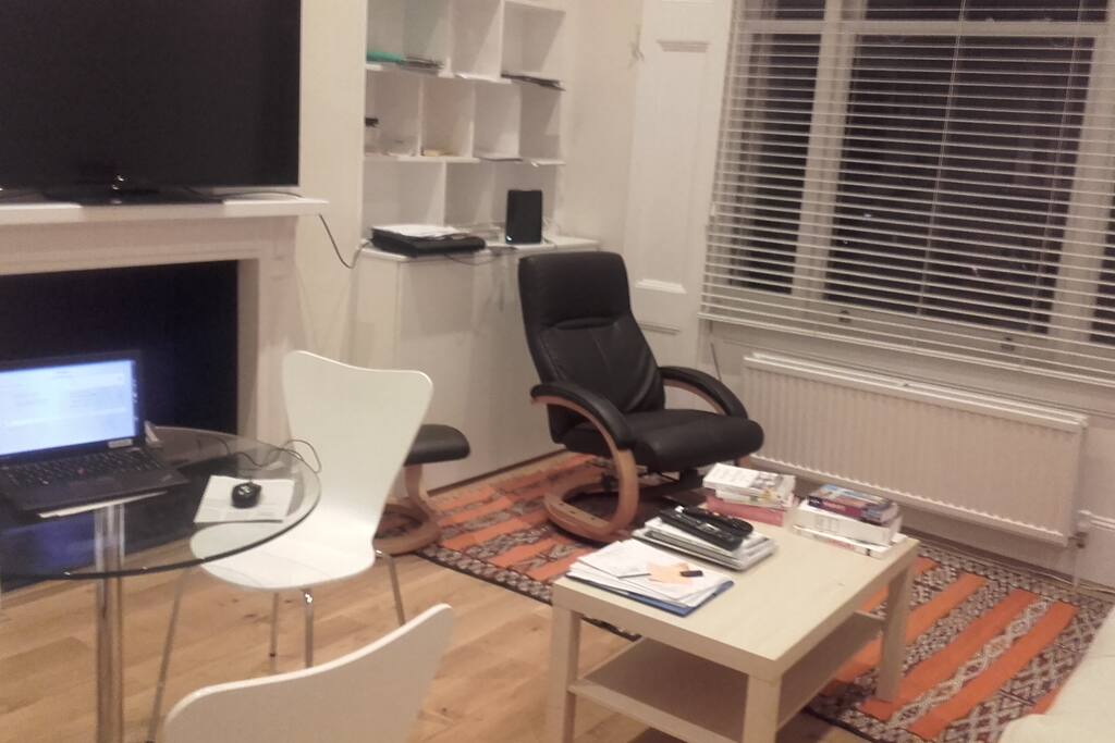Living room with TV and wifi and very large window oriented to the West