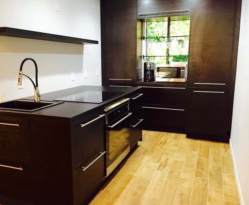 Fully equipped European style kitchen. Can you find the refrigerator?