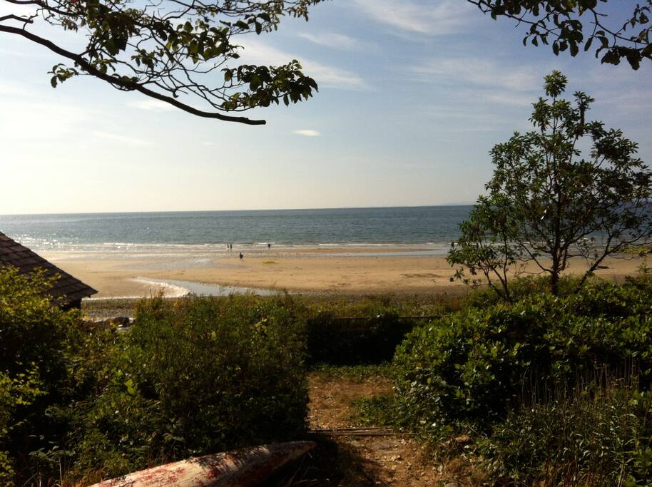 View of beach and boathouse from deck