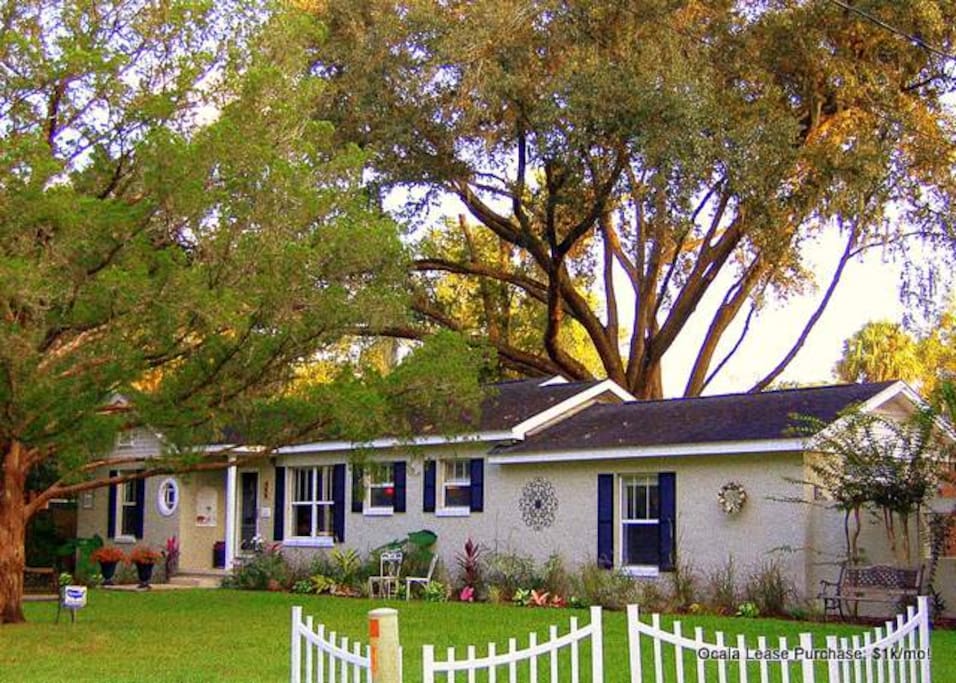 Big oaks shade the historic bungalow