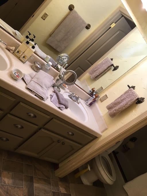 A bathroom with two sinks and a beautiful shower with great water pressure