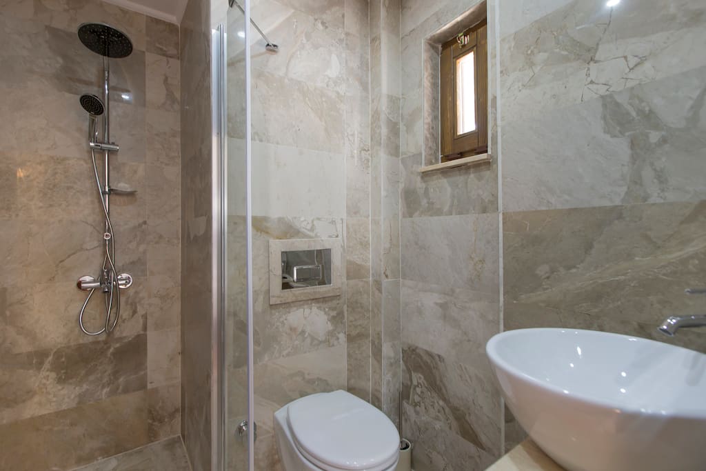 Modern bathroom with powerful shower and locally made olive oil toiletries