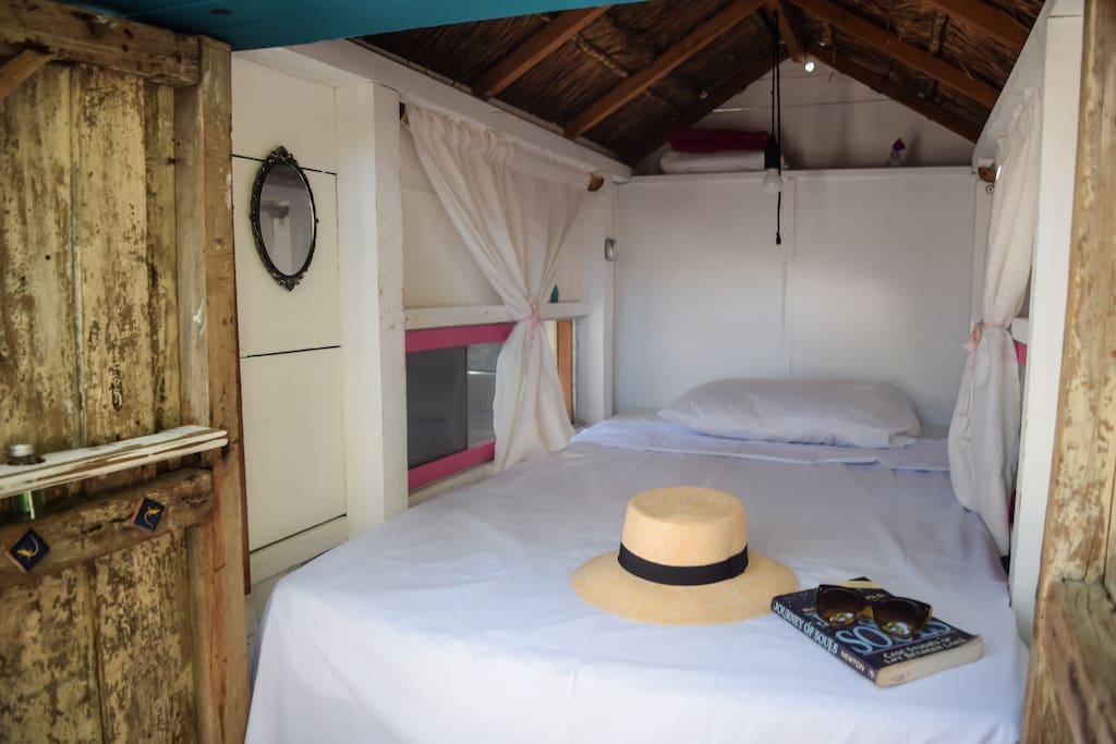 A cozy bed with a warm sea breeze.