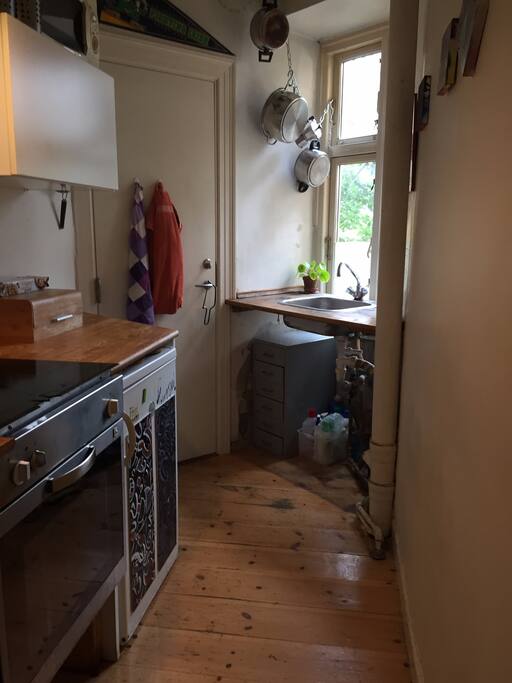 Kitchen with access to the beautiful courtyard. Coffee/tea/spices/breakfast or whatever else is there is free to use during your stay.