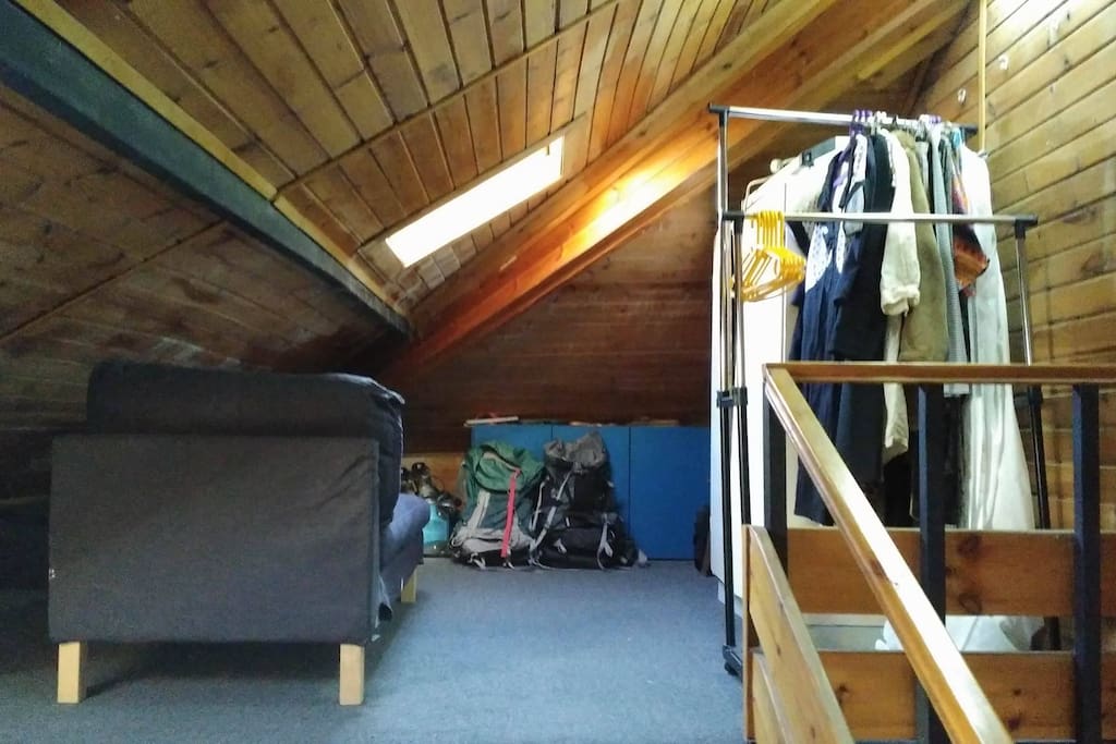 Second half of loft with hanging storage space for you and a day bed