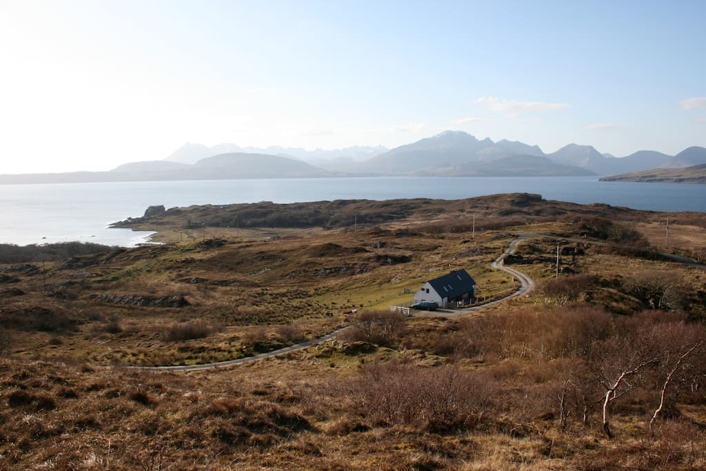 The Longhouse at Tokavaig with the Cuillin mountains in the background
