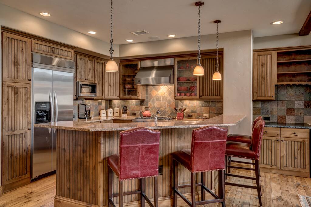 A granite bar has 4 stools for snacks or drinks