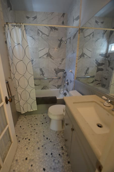 Newly remodeled bathroom with tub and shower combo.