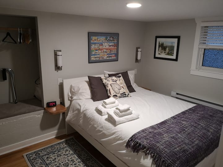 Bedroom 1 with queen bed, natural fir flooring and independent heat control.