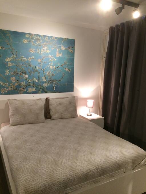 Double bed, completely dark when the curtains are closed.