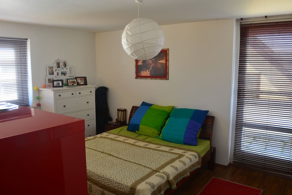 Bedroom with an attached balcony.