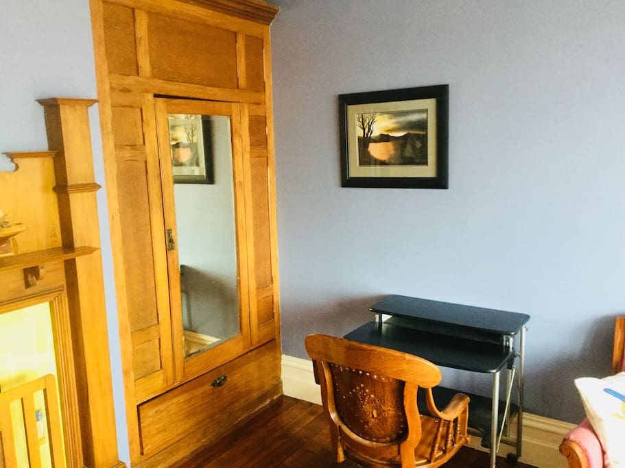 Desk and wardrobe in room
