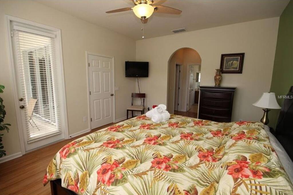 First Bedroom access to the pool, TV and private bath with separate powder room and rest room