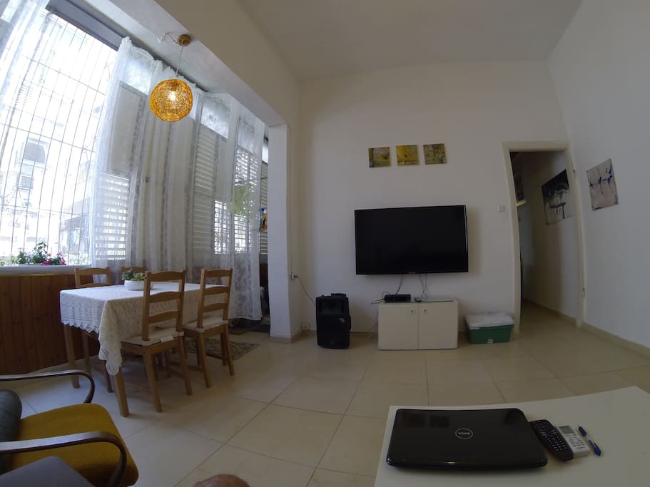 Living room with 55 Inch LED TV and Dining area with huge windows